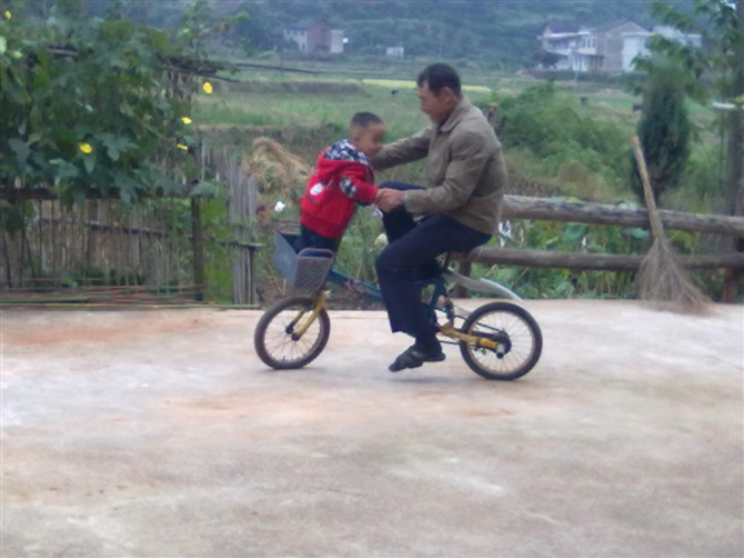 做个合格的父母真不容易\外公骑自行车拉着二岁的儿子骑得可开心了